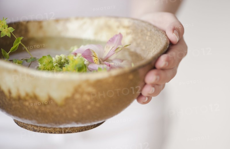 Woman holding aromatherapy bowl.