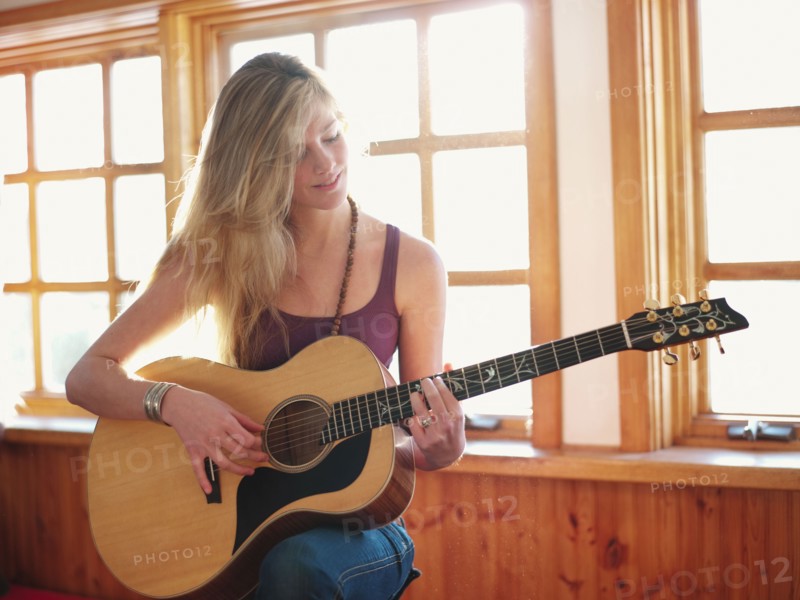 Young woman playing guitar