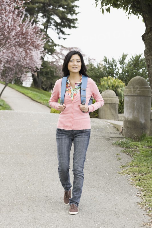 Young woman walking in park, San Francisco, California, USA. Photographe : PT Images