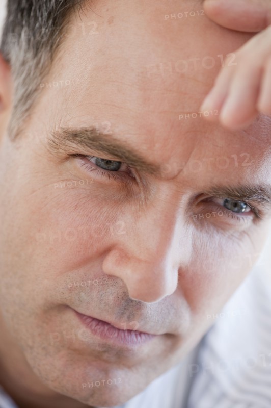 Mature businessman contemplating, close-up.