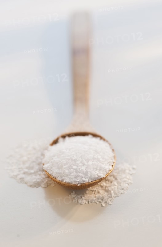 Wooden spoon of salt, studio shot.
