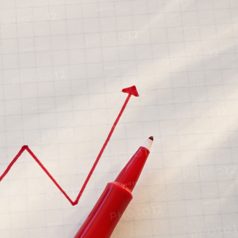 Red line graph with pen.