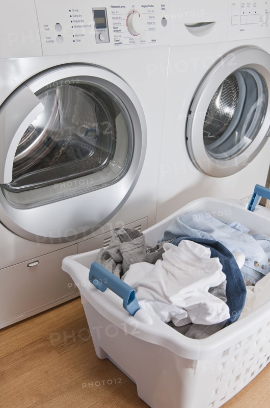Laundry in basket in launderette.