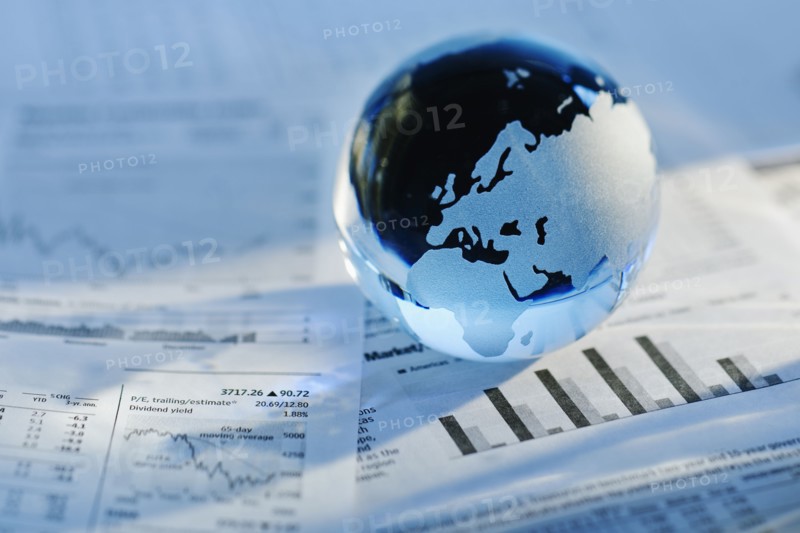 A globe on business papers.