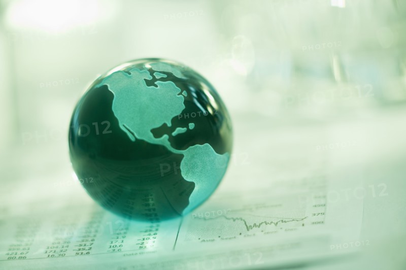 A globe on business papers.