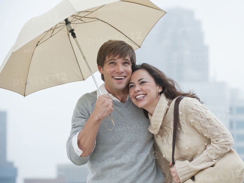 A couple outdoors in the rain.