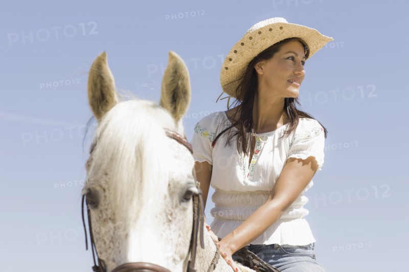 A woman riding a horse