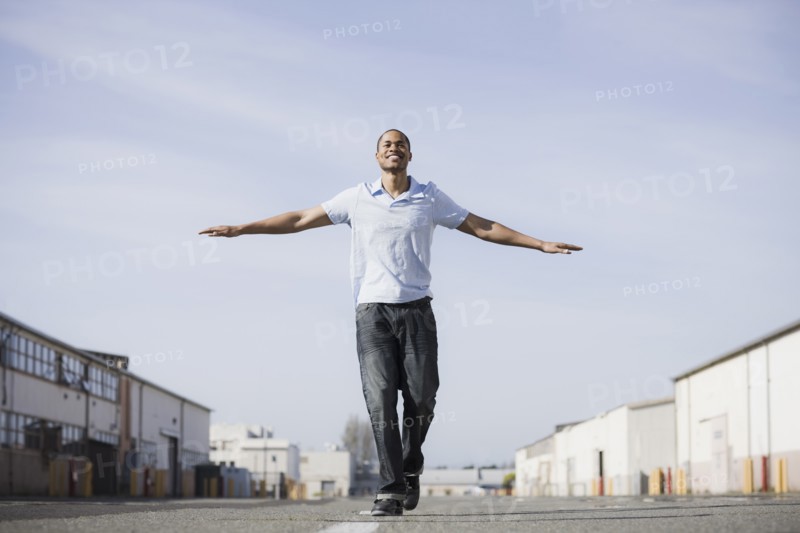 A man walking the line on a road