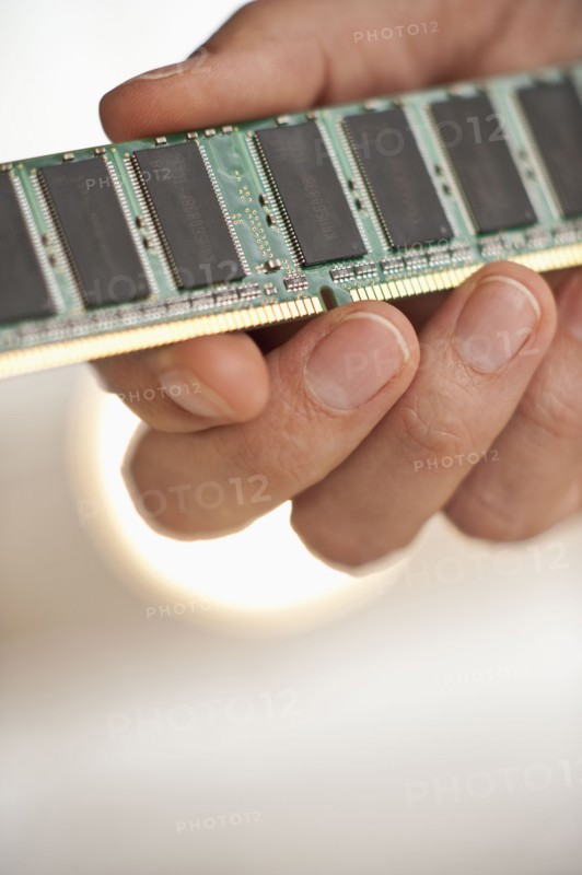 Hand holding computer chips.