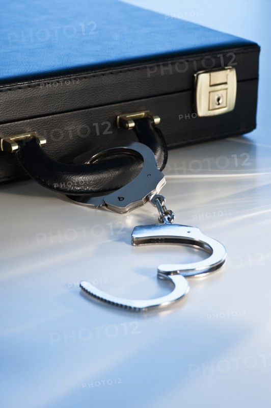 Hand cuffs attached to a suitcase