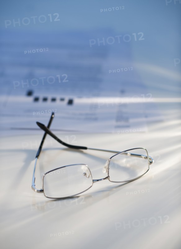 Eyeglasses near some paperwork.