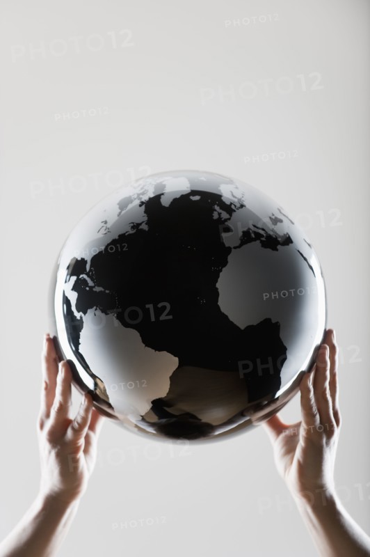 Hands holding a globe.