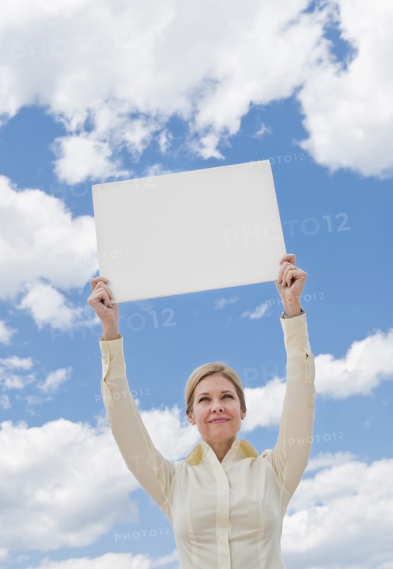 Woman holding a blank sign.