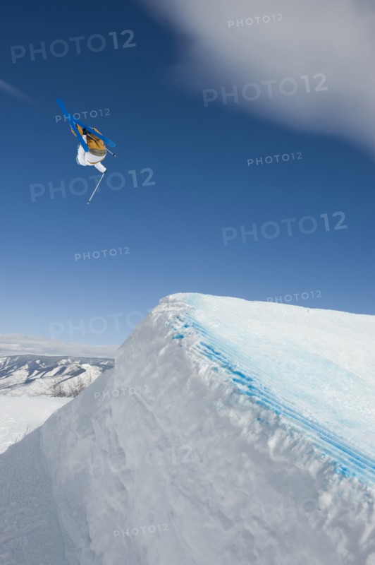 A downhill skier jumping
