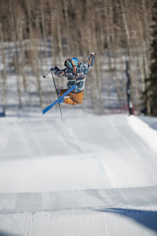 A downhill skier jumping
