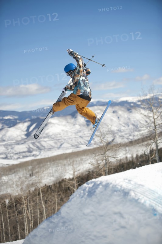 A downhill skier jumping