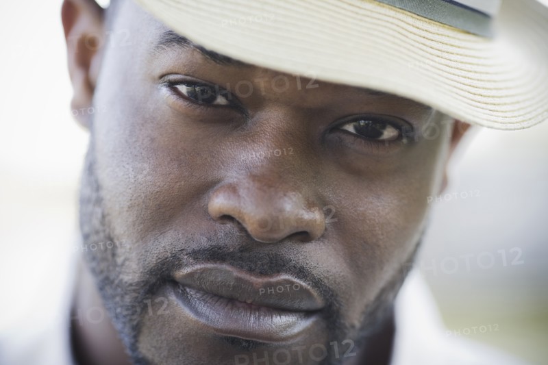 A man outdoors wearing a hat