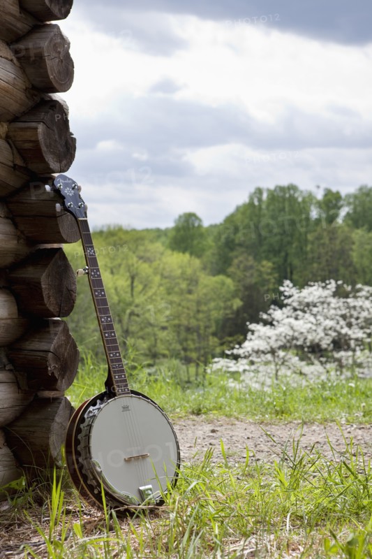 A banjo leaning against the wall of a cabin