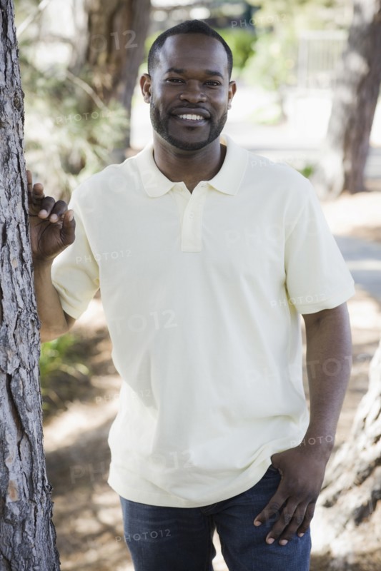 A man outdoors by some trees