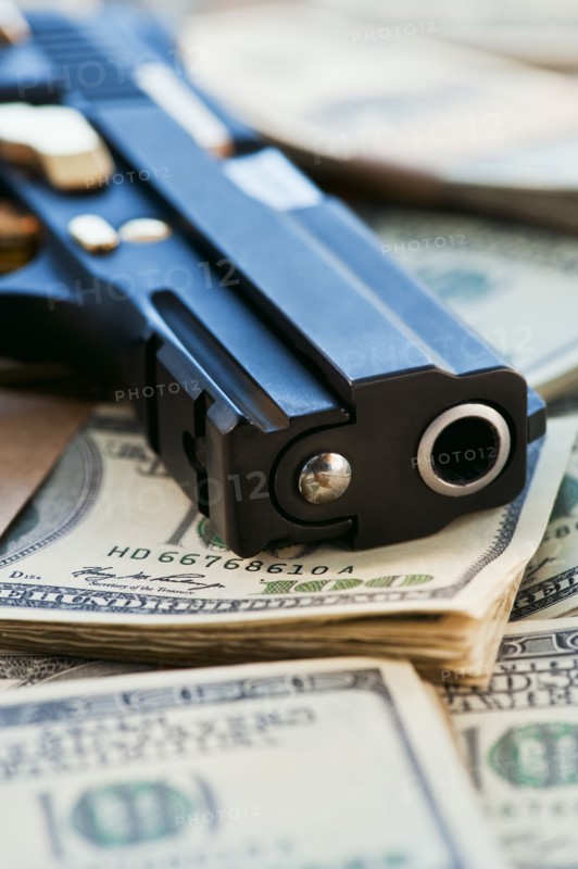 A handgun on stacks of money