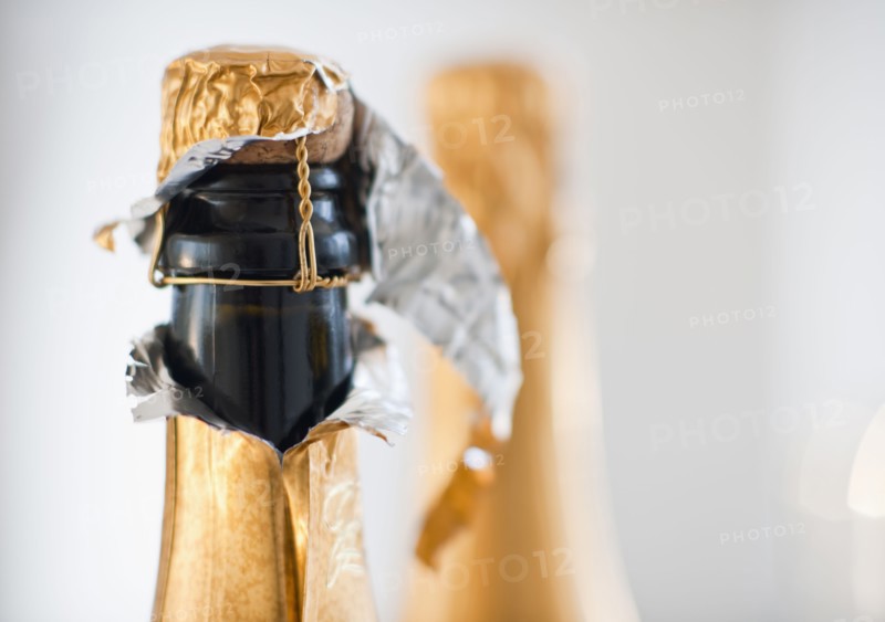 Two champagne bottles.