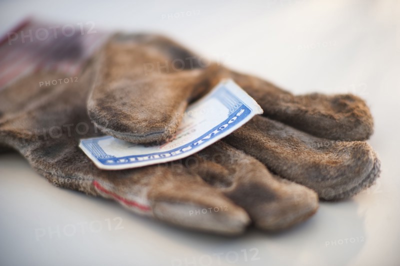 A glove with a social security card on it.