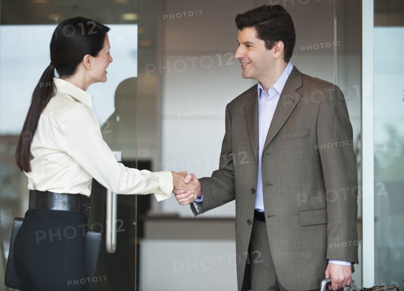 Two business people shaking hands.