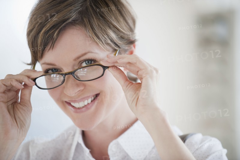 Woman trying on glasses.
