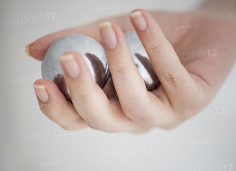 Hand holding Chinese balls.