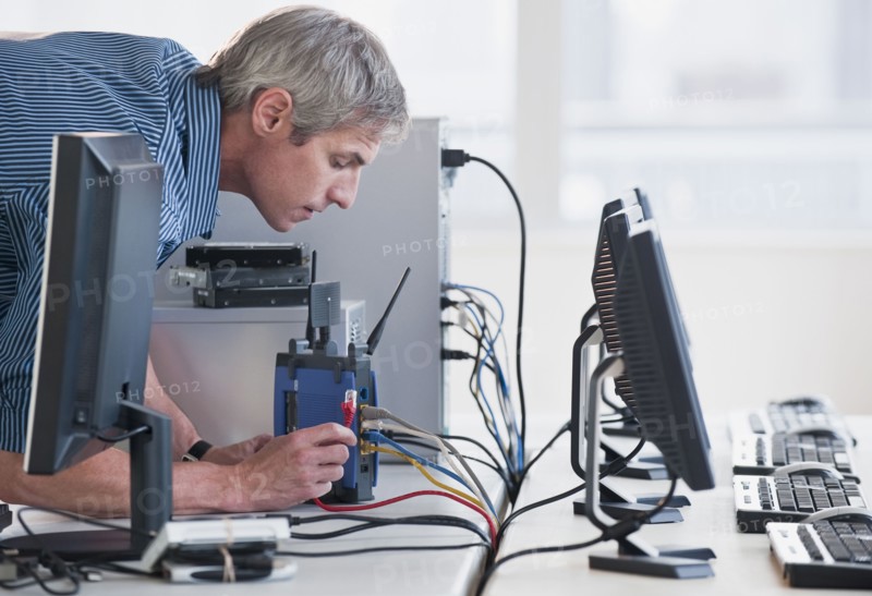 Man with networked computers.