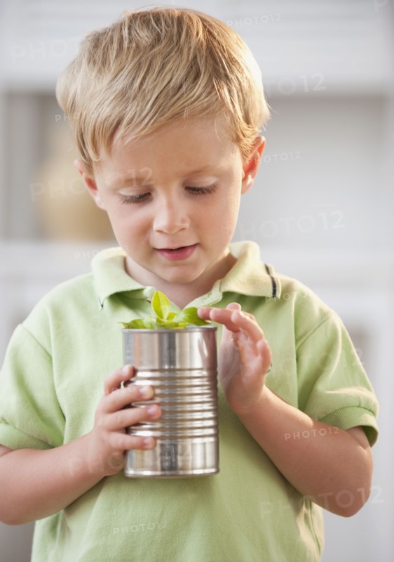 Child examining plant.