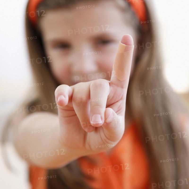Child showing cut on finger