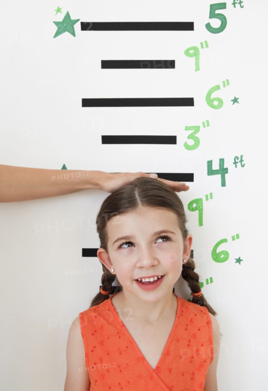 Child having height measured