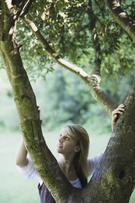 Smiling woman behind tree