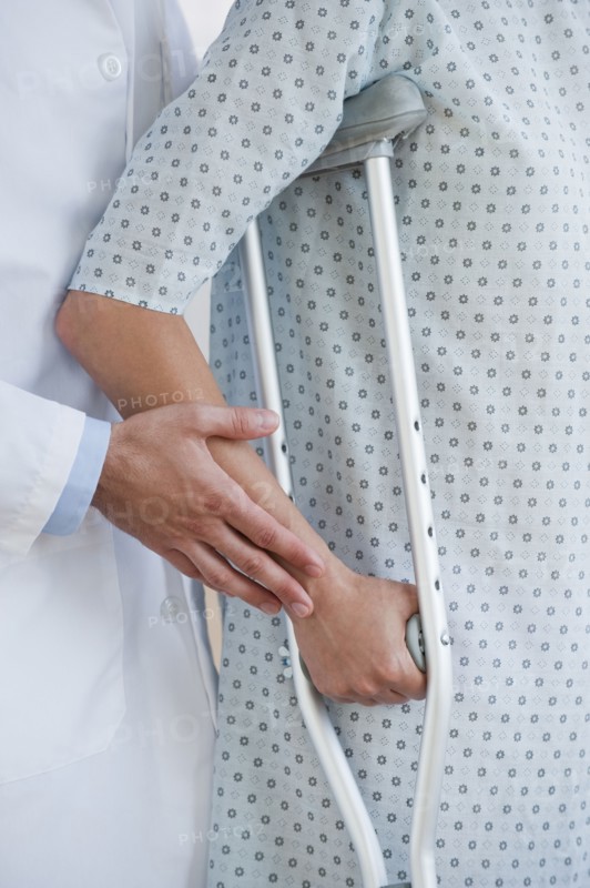 Doctor and patient with crutches.