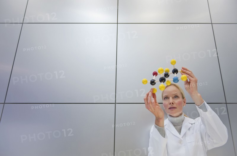 Reeacher holding molecular model.