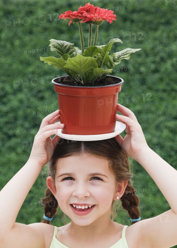 Child with plant on head