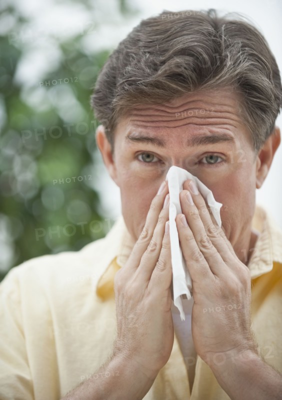 Man blowing nose.