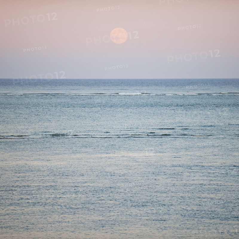 Moonrise over ocean.