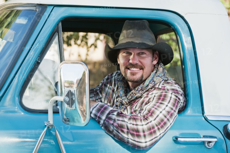 Cowboy driving truck.
