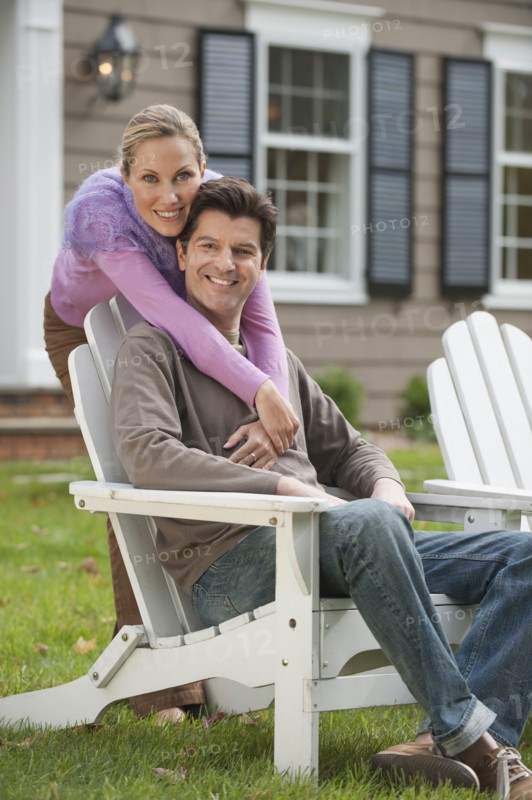 Couple in front of house.