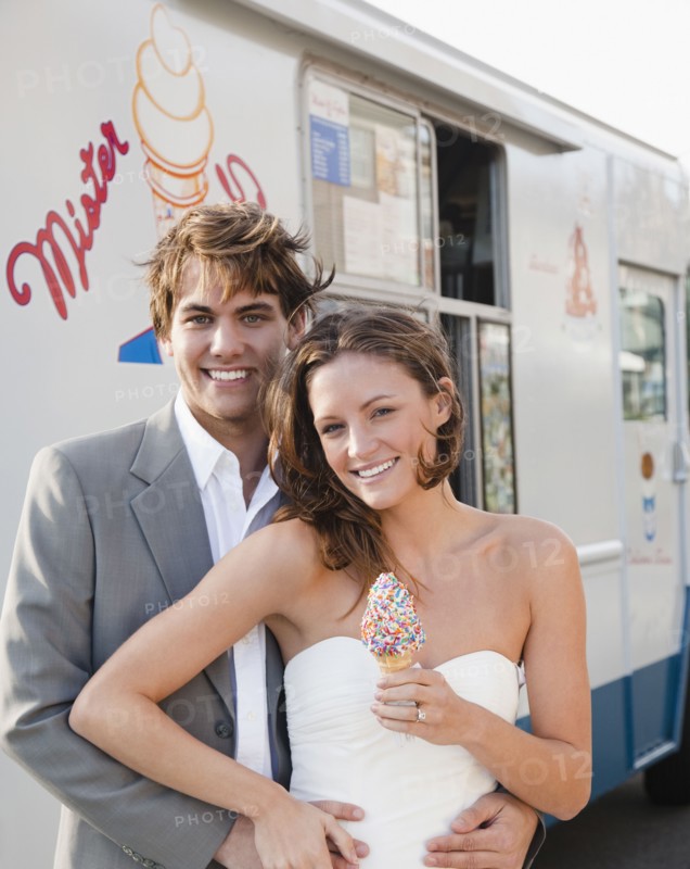 Bride and groom eating ice cream