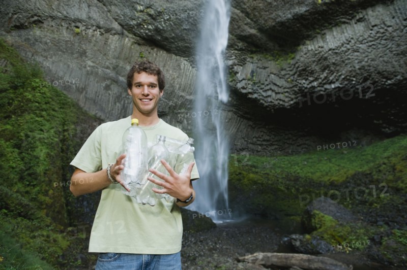 Man holding empty water bottles