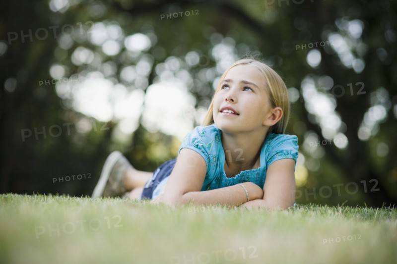 Young girl lying on grass