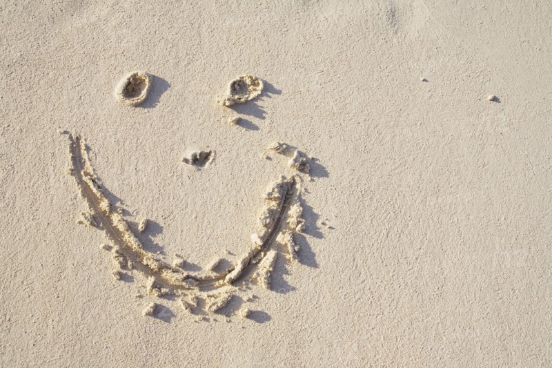 Happy face in the sand