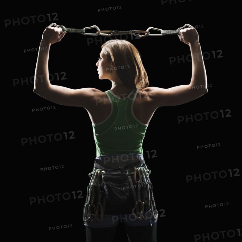 Female climber holding gear