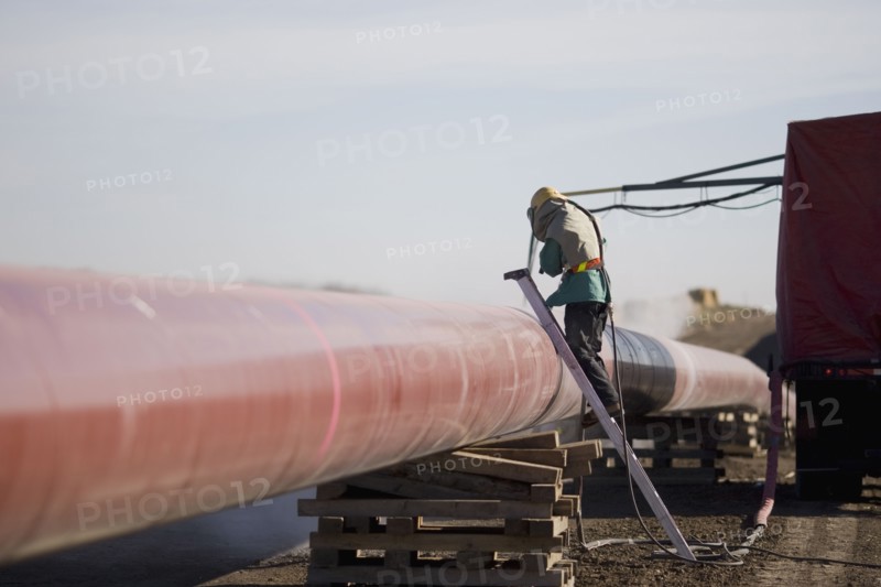 Construction worker cleaning pipleline