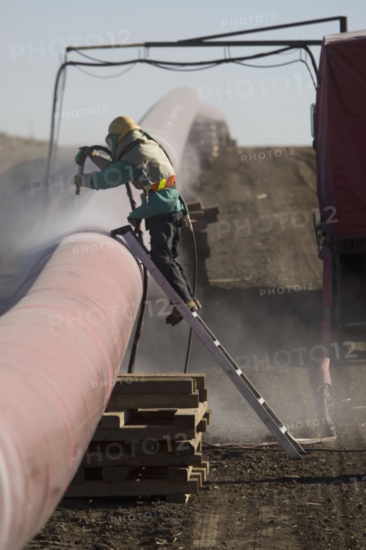 Construction worker cleaning pipleline