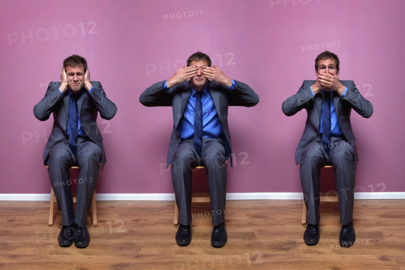 Three businessmen sitting in chairs