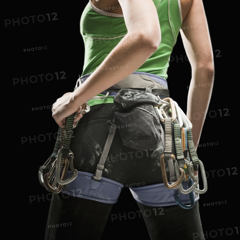 Studio shot of female climber wearing harness